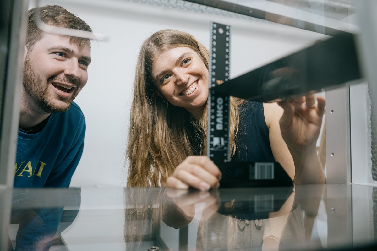 picture of two persons who are measuring something